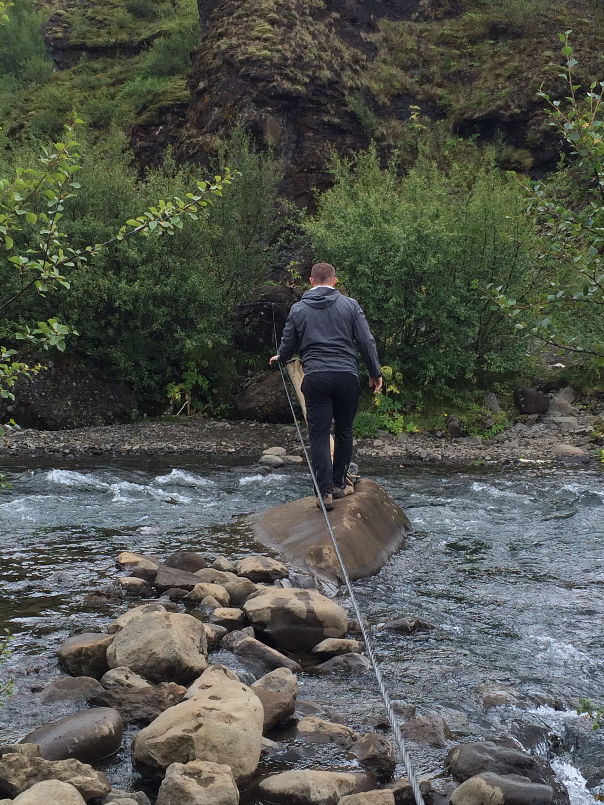 River crossing on a small log on the hike to Glymur Waterfall!