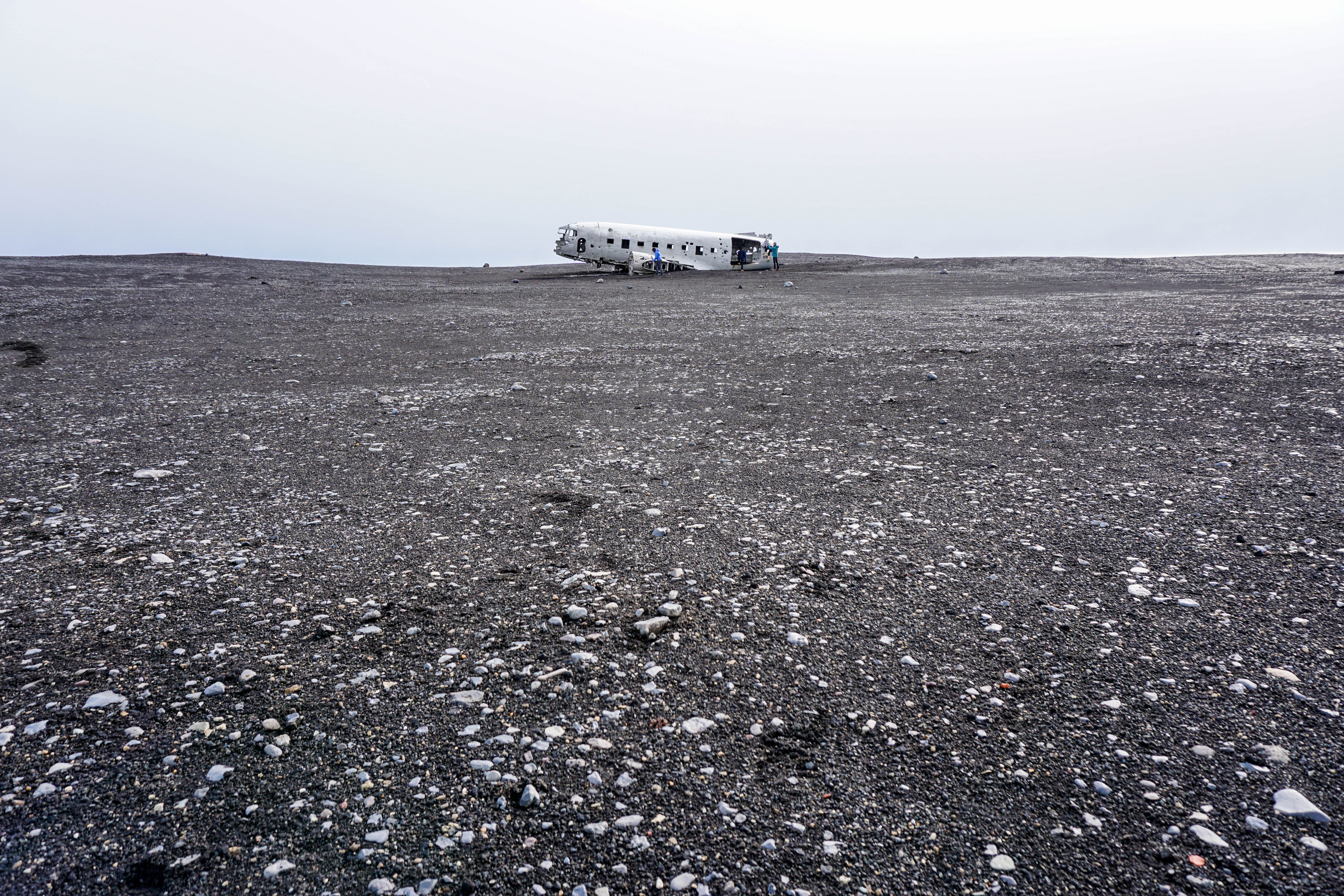 The first glimpse of the amazing yet eerie plane wreck on Solheimasandur black sand beach in South Iceland | Life With a View