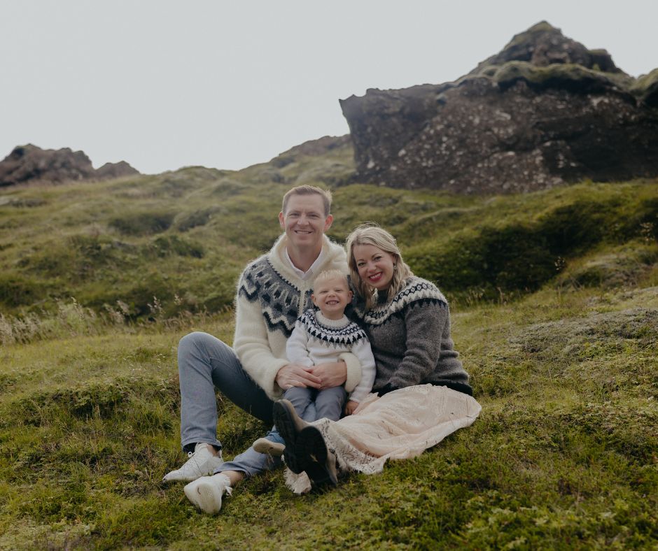 Picture of Jeannie, Husband and Kid Smiling to the Camera Wearing Lopapeysas | Iceland with Kids | Iceland with a View