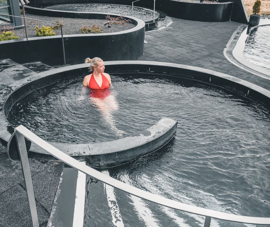 Picture of Jeannie Wearing a Swimsuit (A Must in Iceland Fall Packing List) Inside Krauma Hot Spring | Iceland with a View