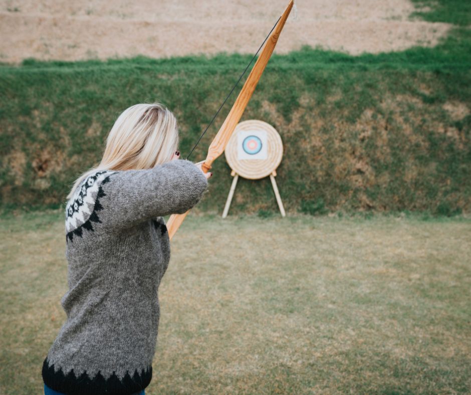 Picture of Jeannie Doing Archery, One of the Fun Activities in the Ingólfsskáli Viking Restaurant | Iceland with a View