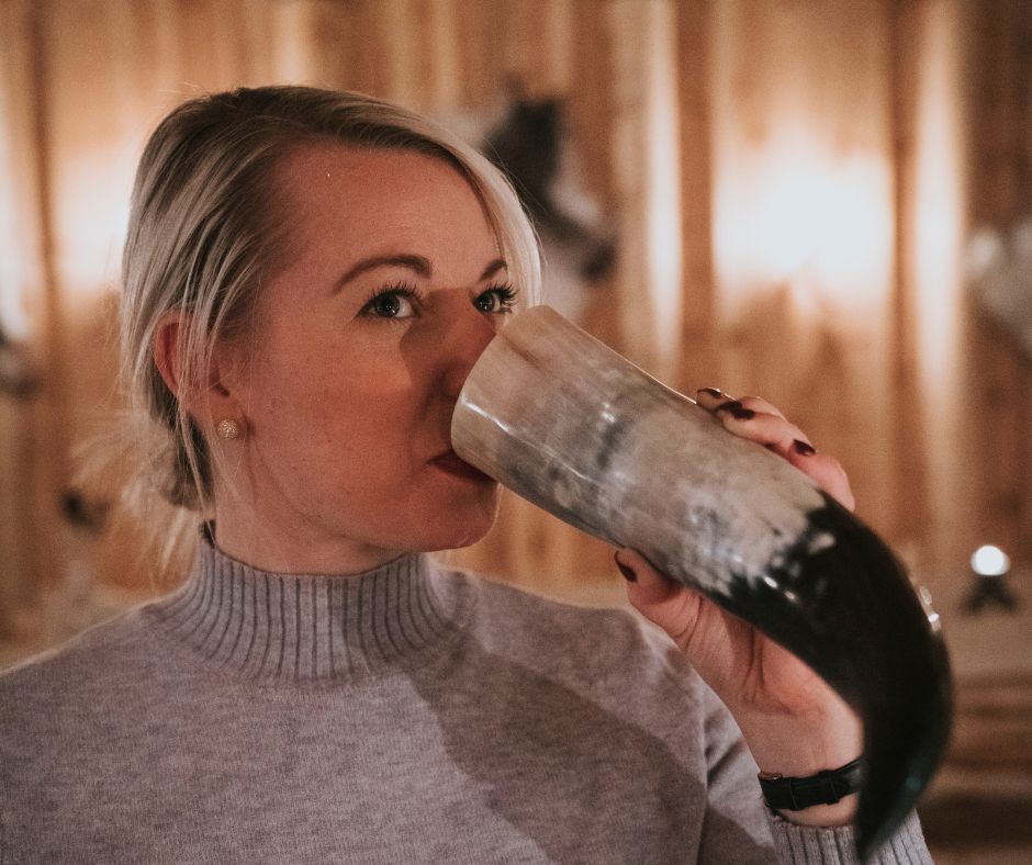 Picture of Jeannie Drinking from a Horn in the Ingólfsskáli Viking Restaurant | Iceland with a View