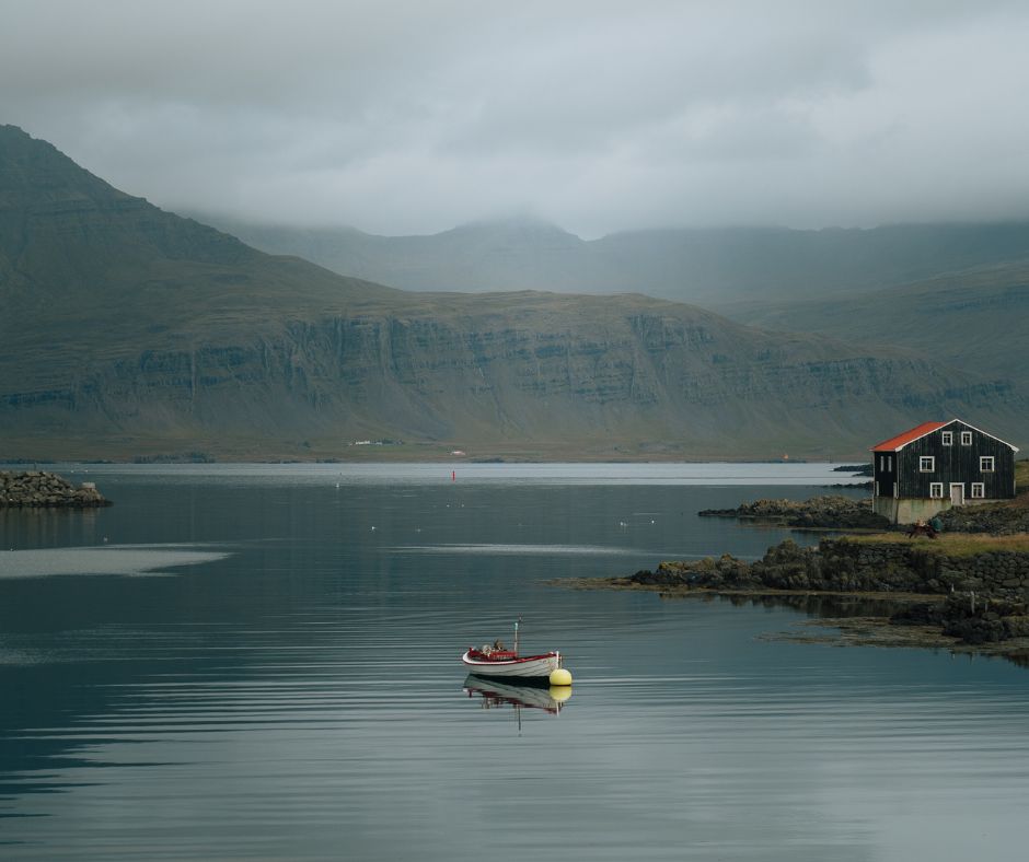 Landscape view of a Boat in the Middle of the Water in Siglufjordur in Iceland | How Cold is Iceland? Blog Post | Iceland with a View