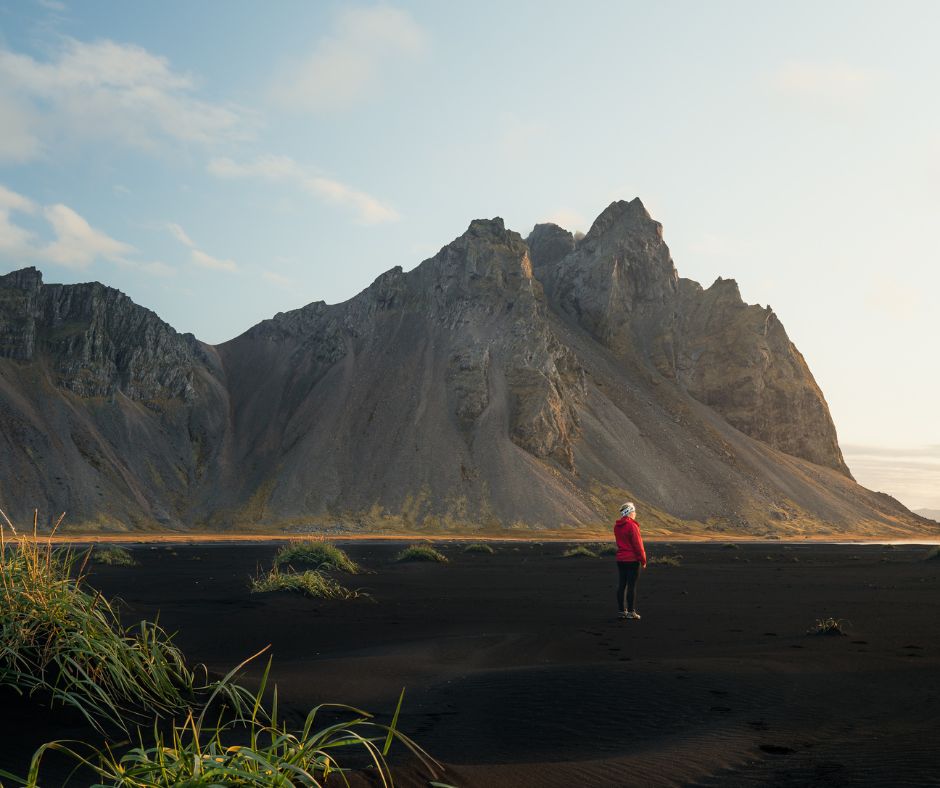Picture of Jeannnie Riley Wearing a Red Raincoat in Stokksness | Iceland with a View