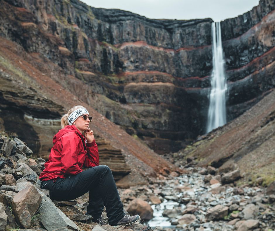 Picture of Jeannie Sitting Close to the Hengifoss Waterfall in Iceland |Iceland with a View 