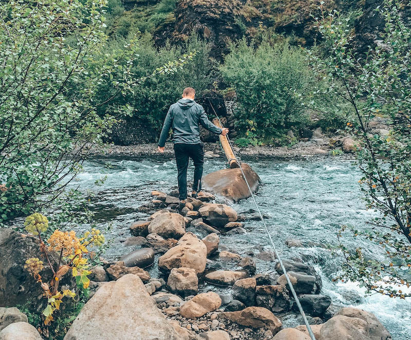 Picture of Jess Husband Crossing the River Using Extreme Precaution and Holding on to a Rope | Glymur Waterfalls | Iceland with a View 