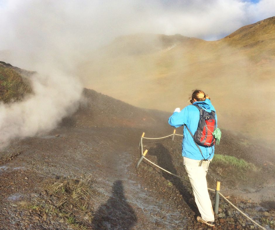 Picture of Jeannie Walking in the Middle of the Reykjadalur Steam Valley | Reykjadalur Hot Spring Hike | Iceland with a View 