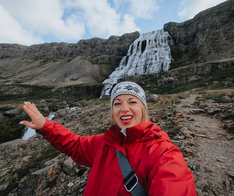 Picture of Jeannie Wearing a Red Rain Coat and a Headband while Visiting Dynjandi Waterfall | Iceland with  a View 