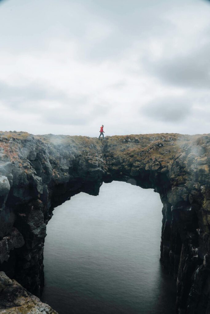 Picture of Jeannie Walking on Rock Arch in Snaefellsnes, Part of the Iceland Itinerary | Iceland with a View