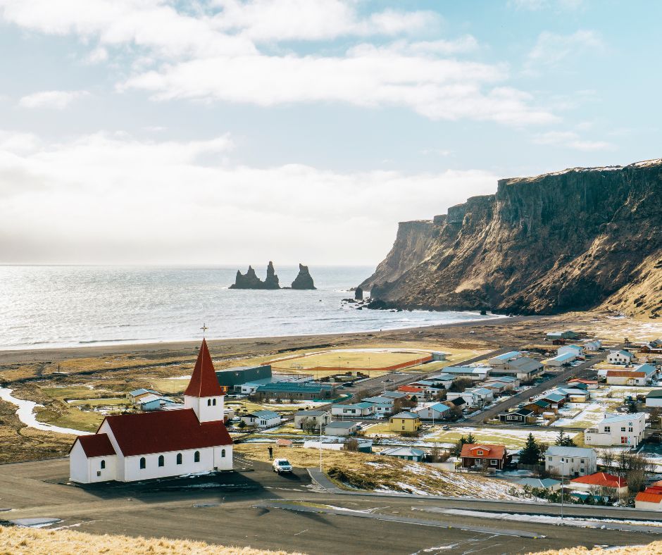 Landscape View of Vík in Iceland, Including the Famous Church and Reynisfjara Beach in the Background | Iceland with a View