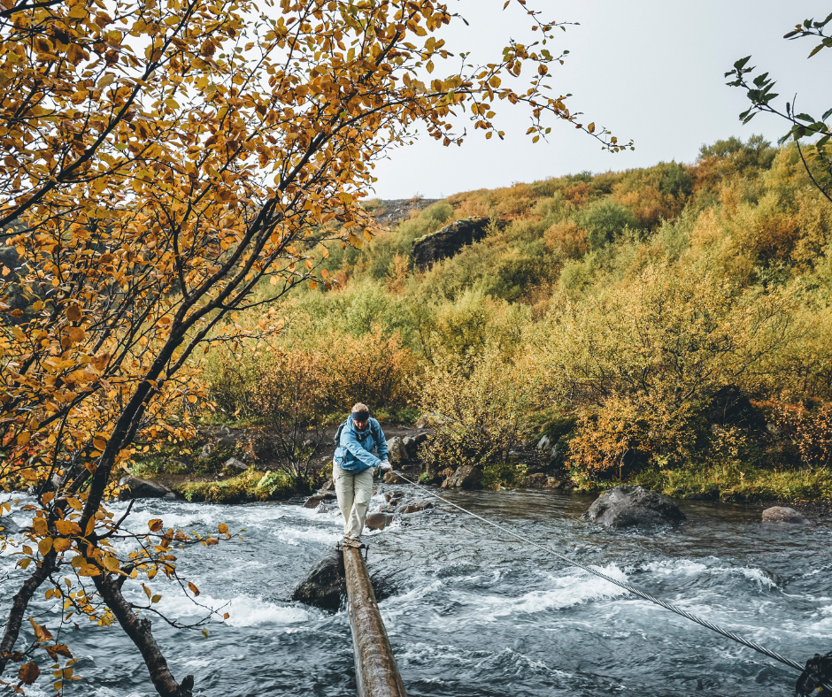 Picture of Jeannie Crossing the River to Glymur Waterfall in Fall in Iceland | Iceland with a View