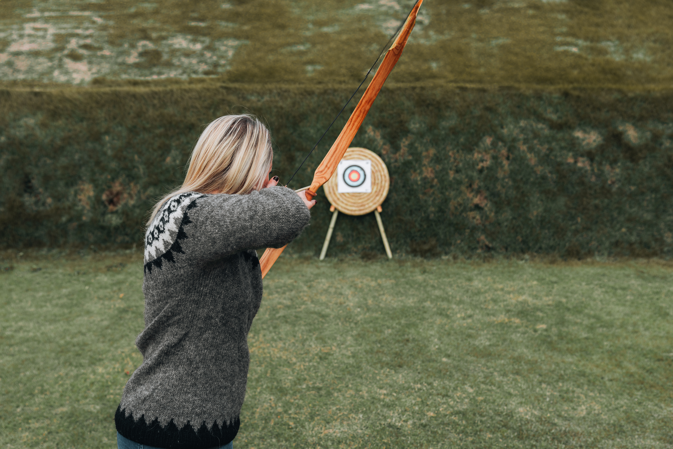 Picture of Jeannie Doing Archery, One of the Fun Activities in the Ingólfsskáli Viking Restaurant | Iceland with a View