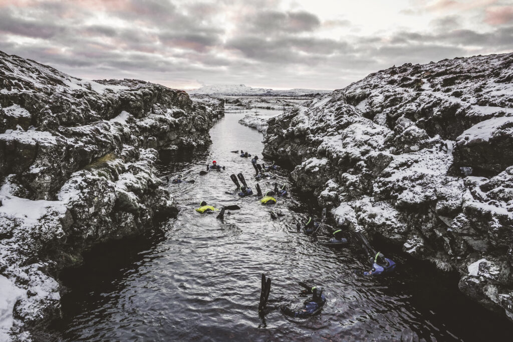 Landscape View of People Snorkeling in Silfra in Iceland | Iceland with a View