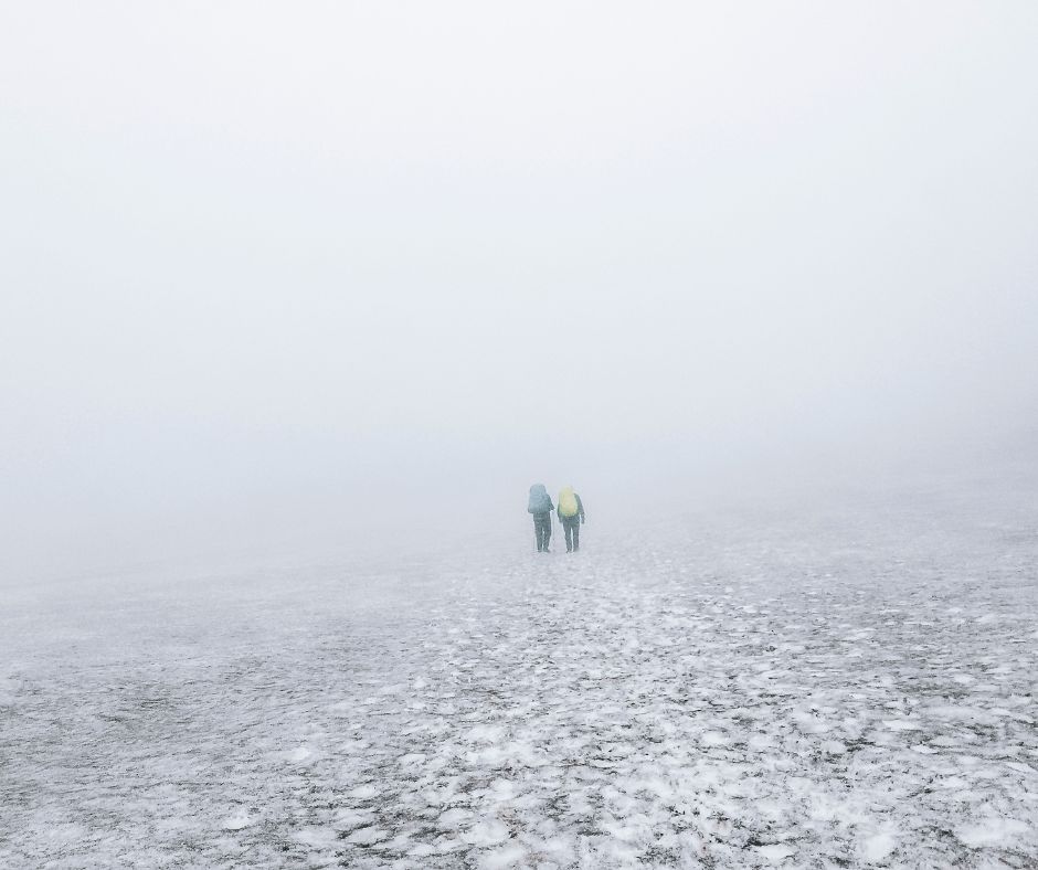 Picture of Two People Walking Across the Fog in Iceland | Bad Weather in Iceland | Iceland with a View