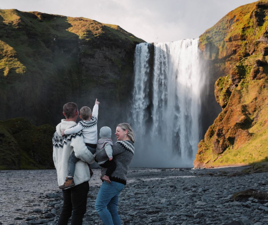 Picture of Jeannie and Her Husband Showing Skógafoss to their Children | Iceland with a View