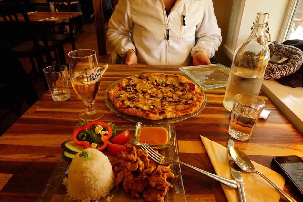 Picture of a Pizza Plate and Plate of Rice and Chicken in Sudur, a Restaurant in Vík | Iceland with a View 