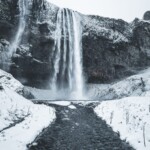 Picture of Jeannie on the Bridge to See Seljalandsfoss Up Close, One of the Waterfalls You Get to See in Thorsmork | Iceland with a View